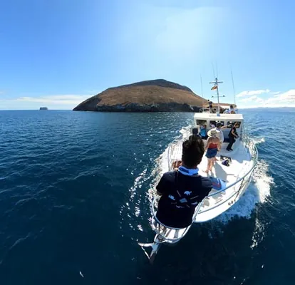 Yacht sailing in front of a Galapagos island